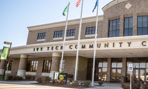 Ivy Tech Community College's modern brick exterior, large windows, and flags create a welcoming, proud, and community-focused atmosphere.