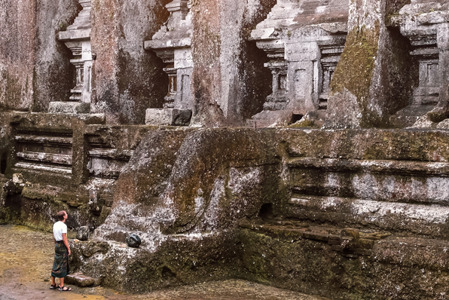 man standing alone in front of ancient sacred royal tombs Gunung Kawi..jpg