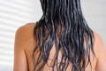 woman with black wet hair shot from behind