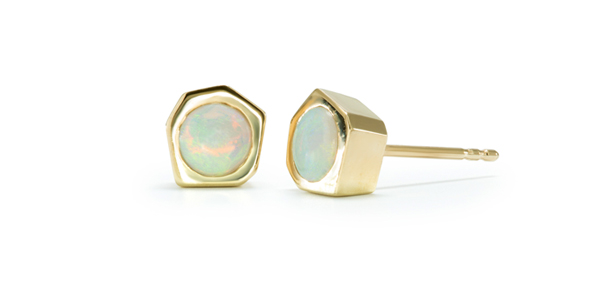 Gold button earrings with opals set in an entirely hand-carved hexagonal center.
