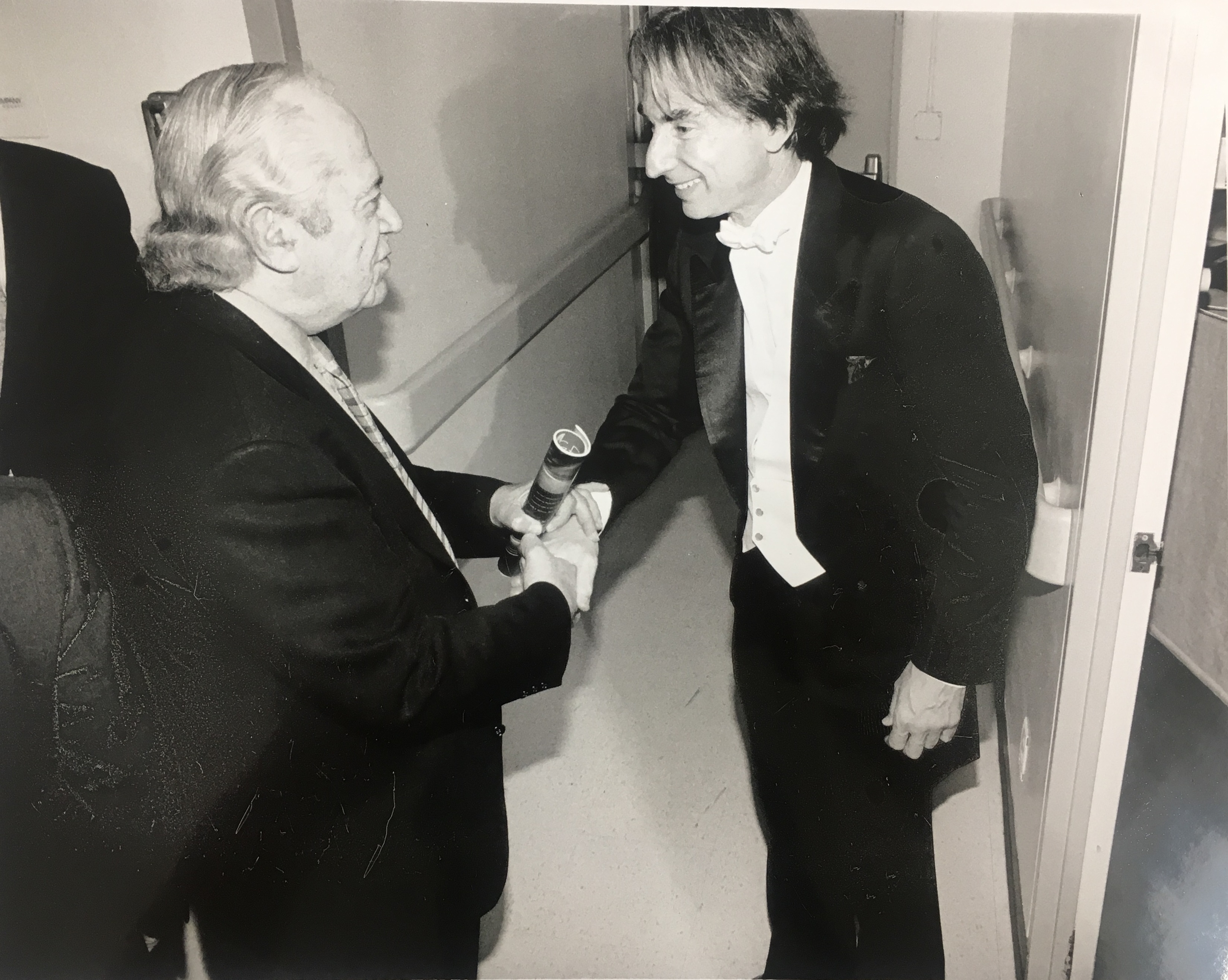 Former LA Phil Principal Guest Conductor Michael Tilson Thomas shakes the hand of the man who gave him the job, former General Manager Ernest Fleischmann.