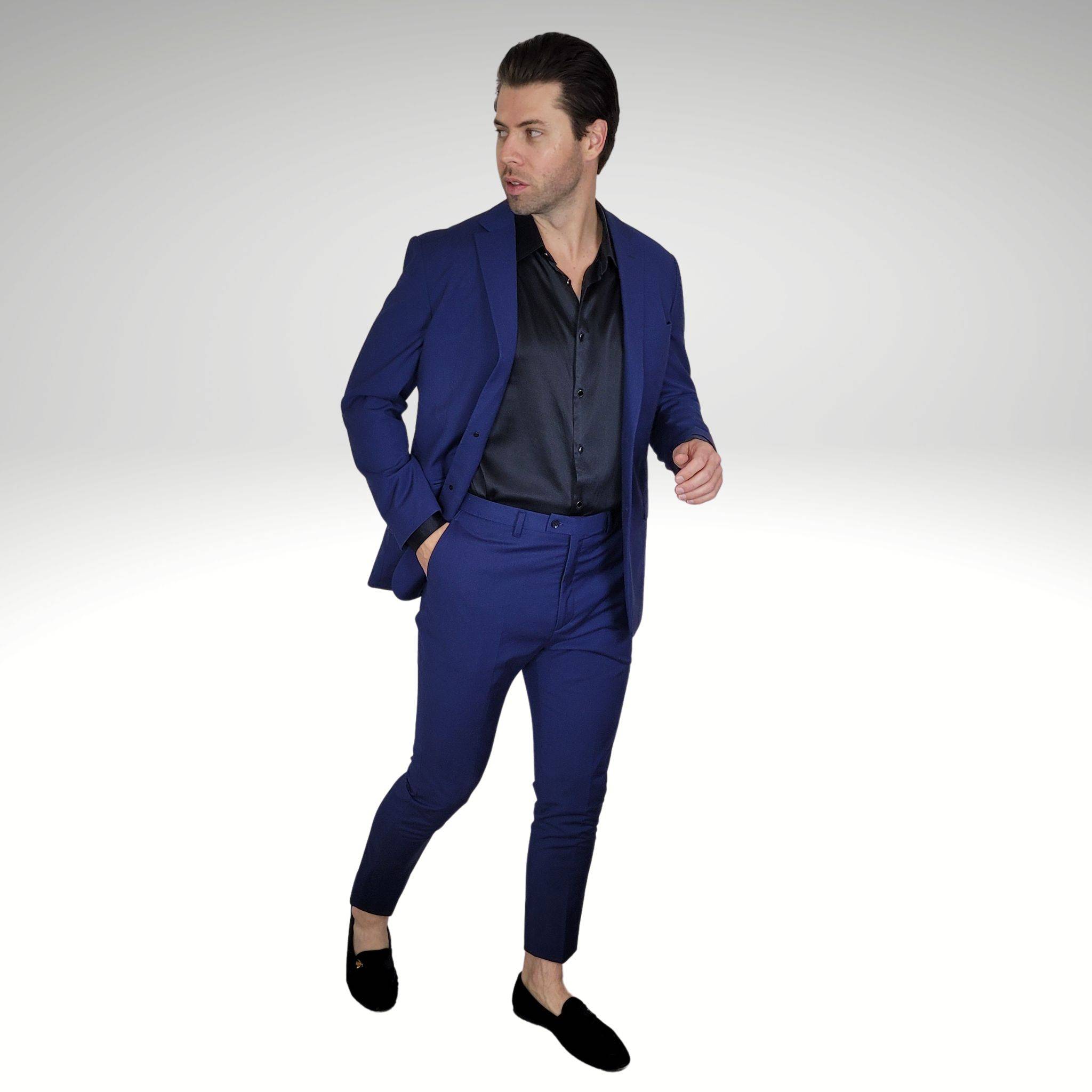 model wearing a black silk shirt with a navy blue suit and black velvet loafers