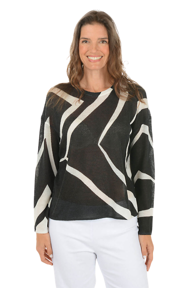 A woman wears a black and white wavy striped sweater.