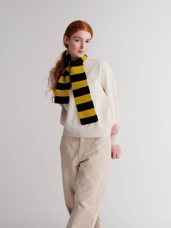 model wears  Small Bold Stripe Garter Stitch Scarf Black & Turmeric
