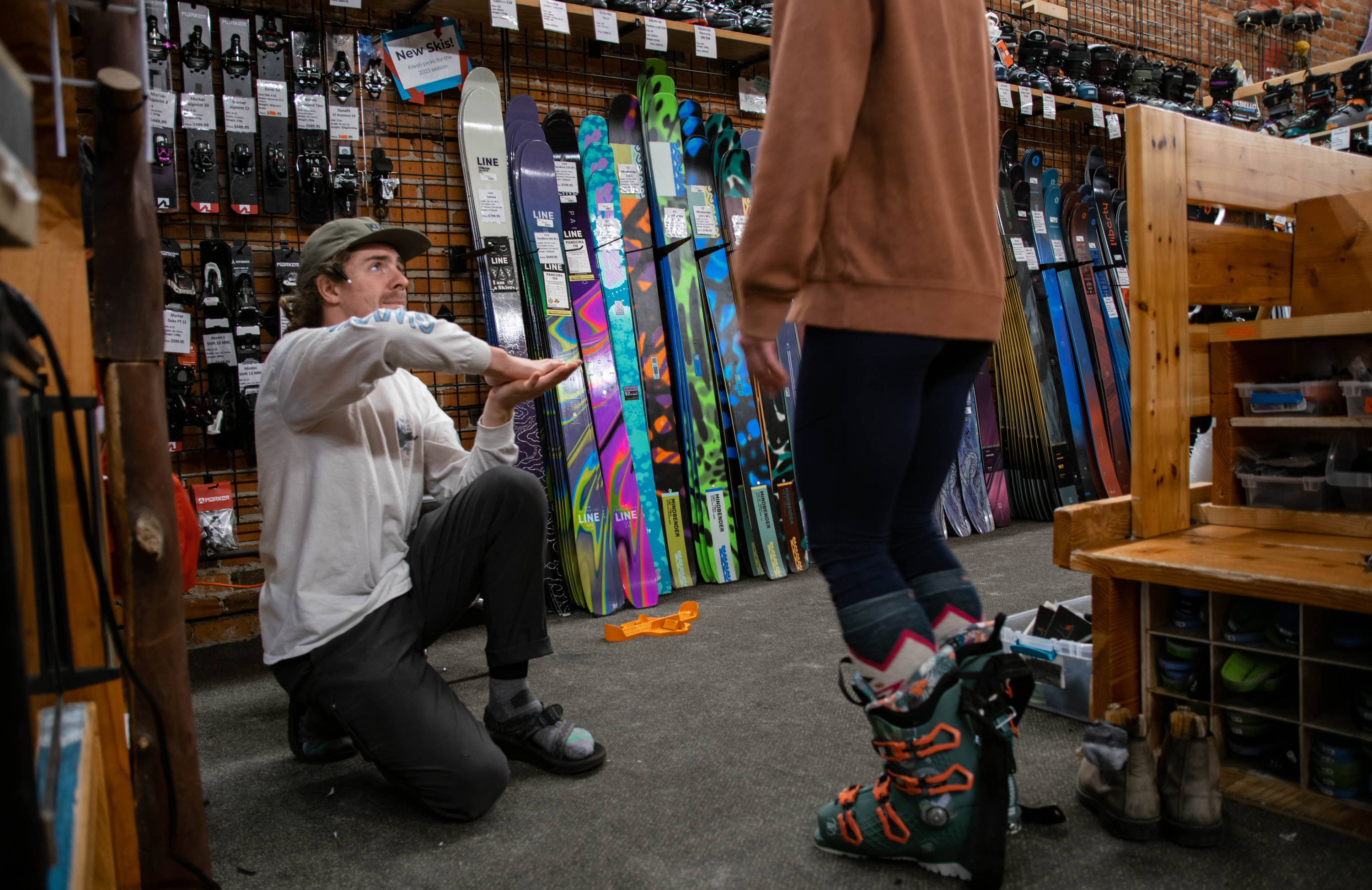 A bootfitter working with a customer.