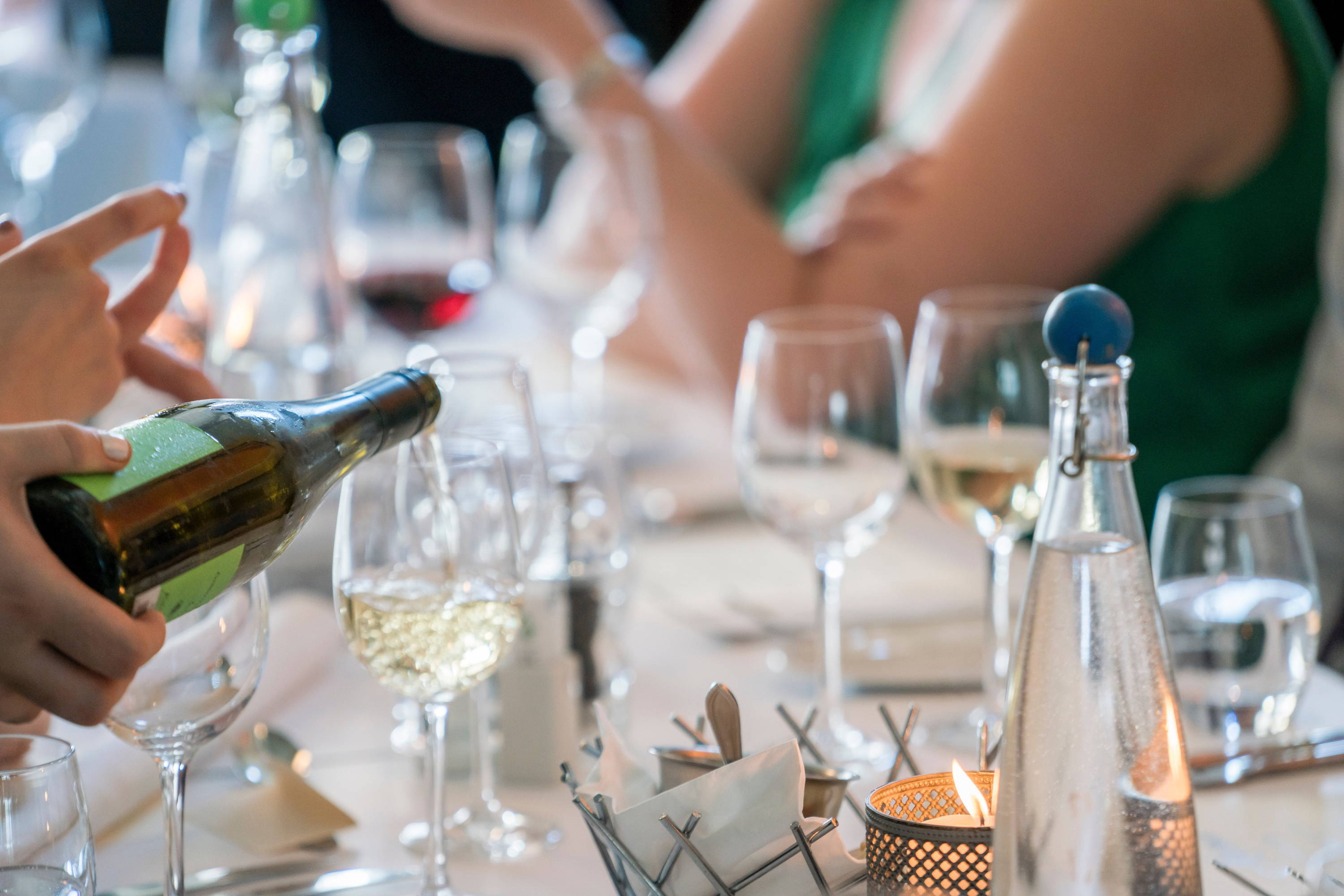 Table top at restaurant with full of wine glasses showing different wine types.  