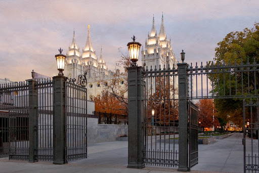 Photo fo the Salt Lake Temple behind entrance gates.