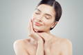 a happy woman enjoying a facial at the spa. appearing young and happy