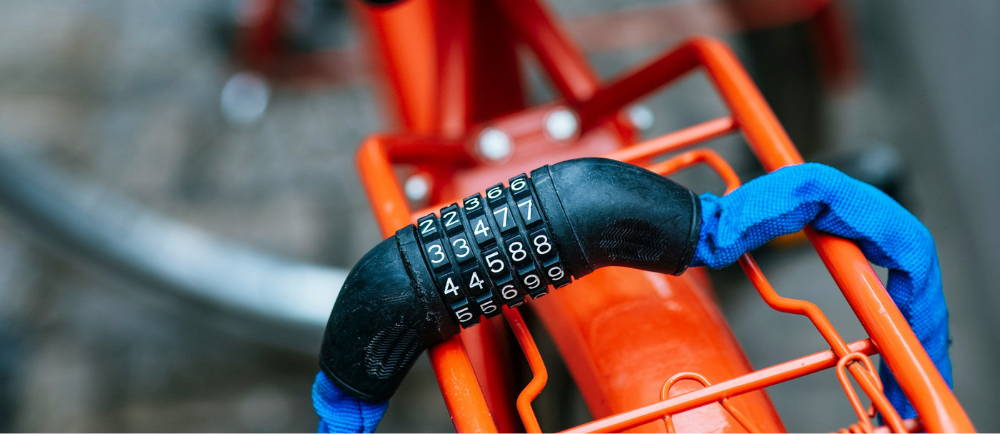 Chain combination lock on orange bike