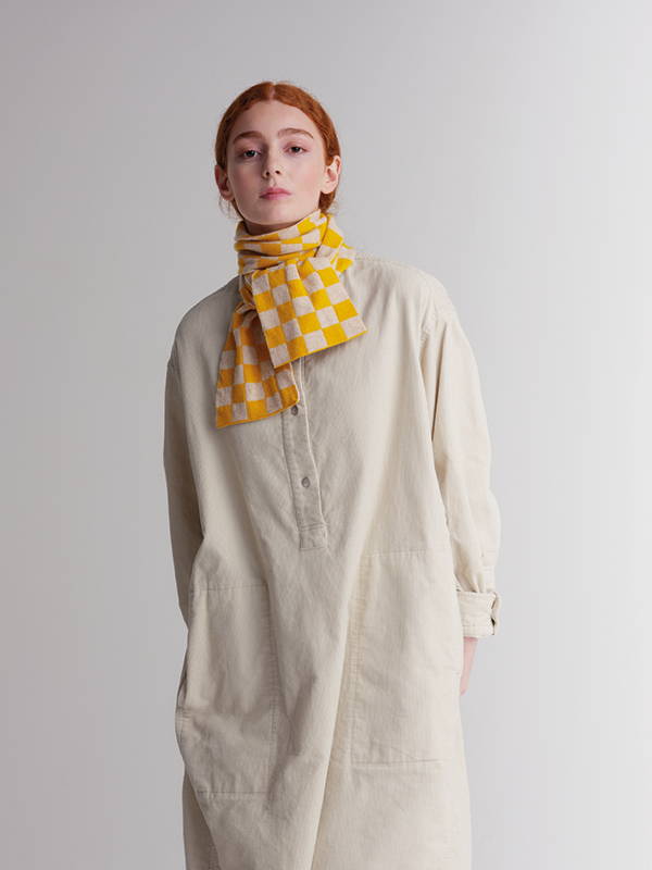model wears  Small Chequered Scarf Golden Eye & Oatmeal