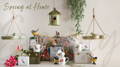 A display of spring-related products, like bird feeders and a hanging bird bath