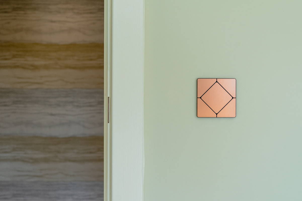 Faradite TAP light switch in brushed copper on a Loxone smart home