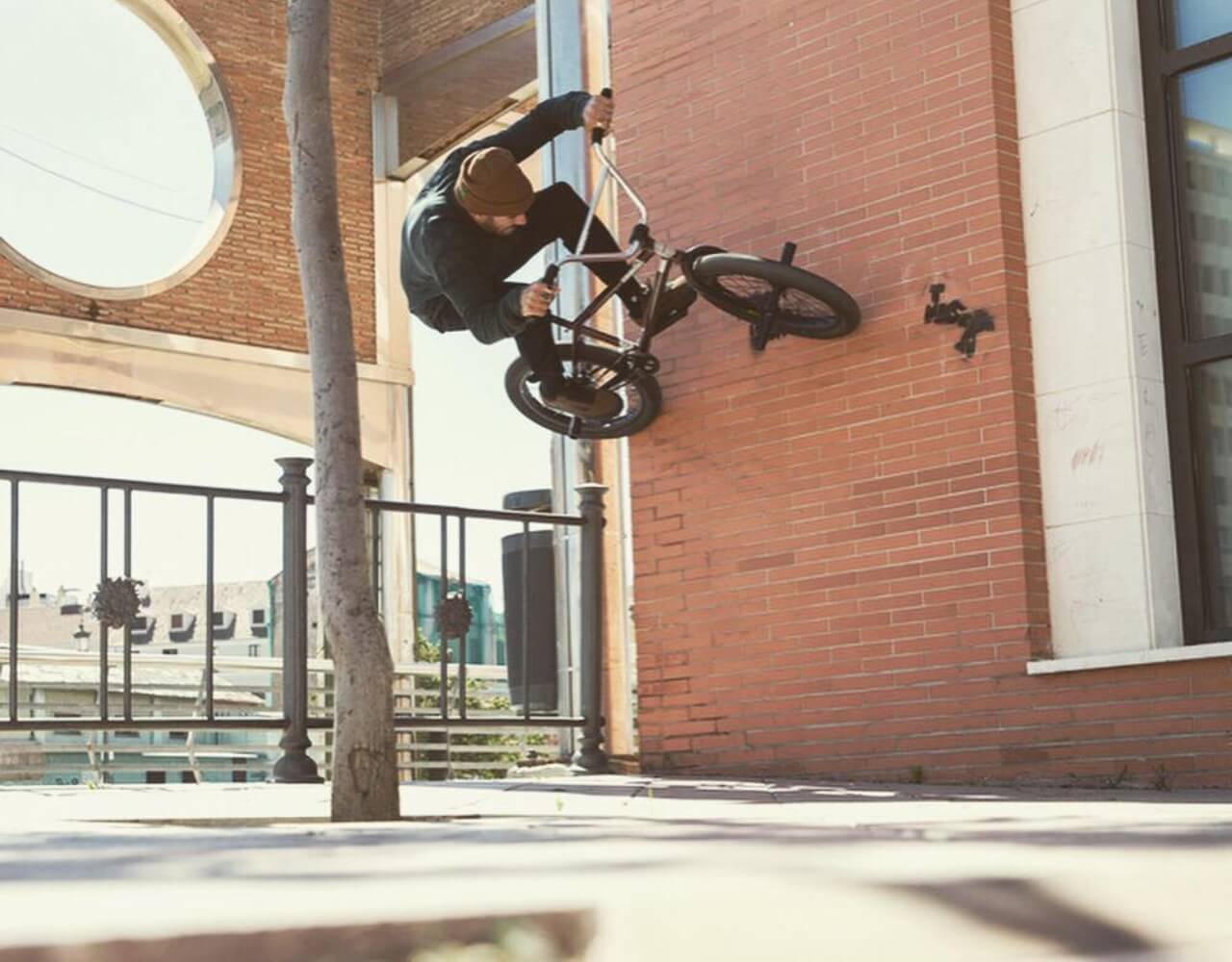 Dakota doing a trick on a bike in a wall