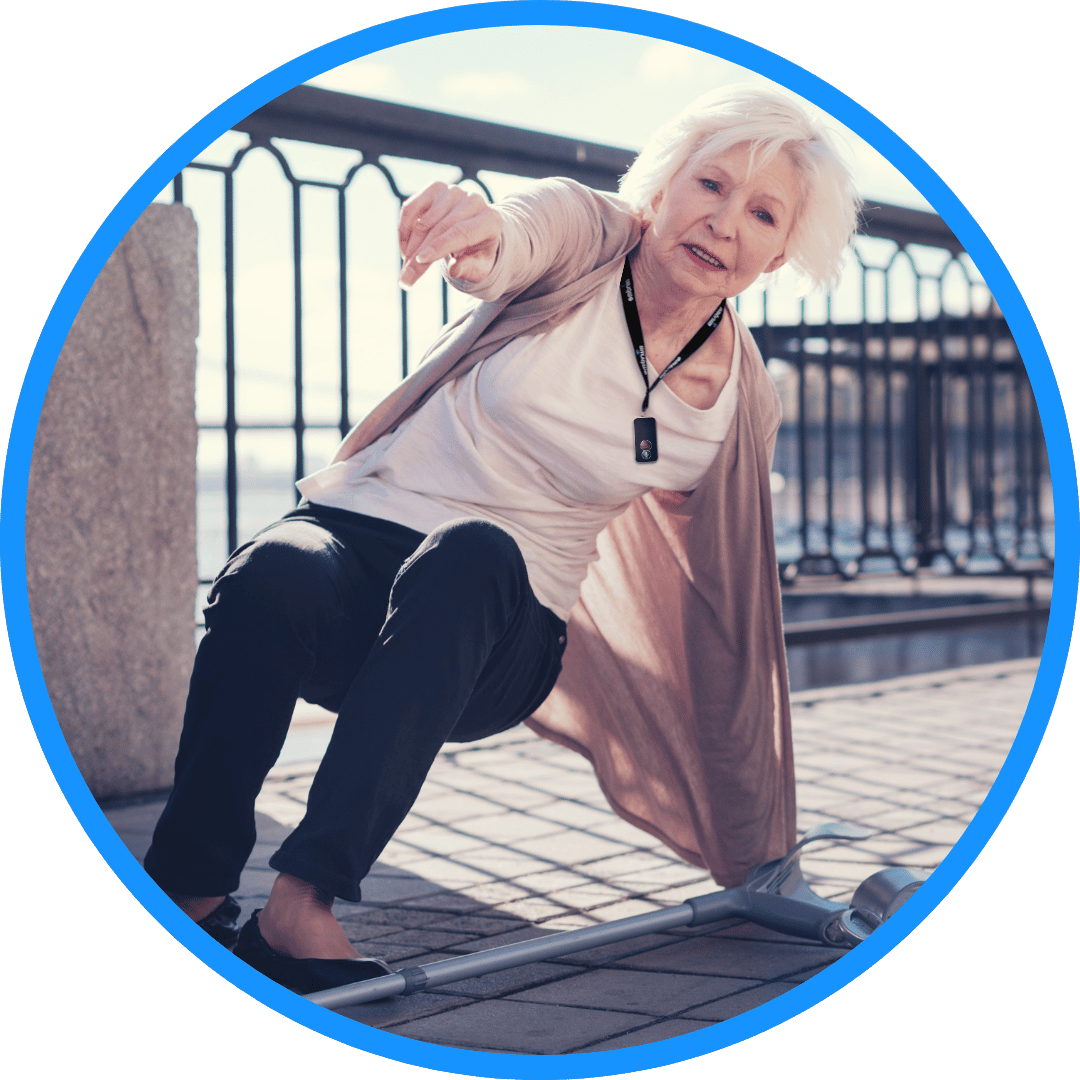 Elderly person wearing a MindMe Pro SM 4G SOS GPS pendant falling in the street, with built-in sensors automatically activating the fall detection procedure. Text reads: 'The wearer falls and a fall is detected.' The MindMe Pro SM is a trusted SOS alarm for the elderly in Australia, delivering immediate emergency assistance.