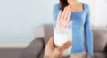 lactose intolerant woman refusing a glass of milk - downsides of whey protein