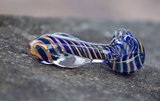 glass hand pipe with blue and orange swirls
