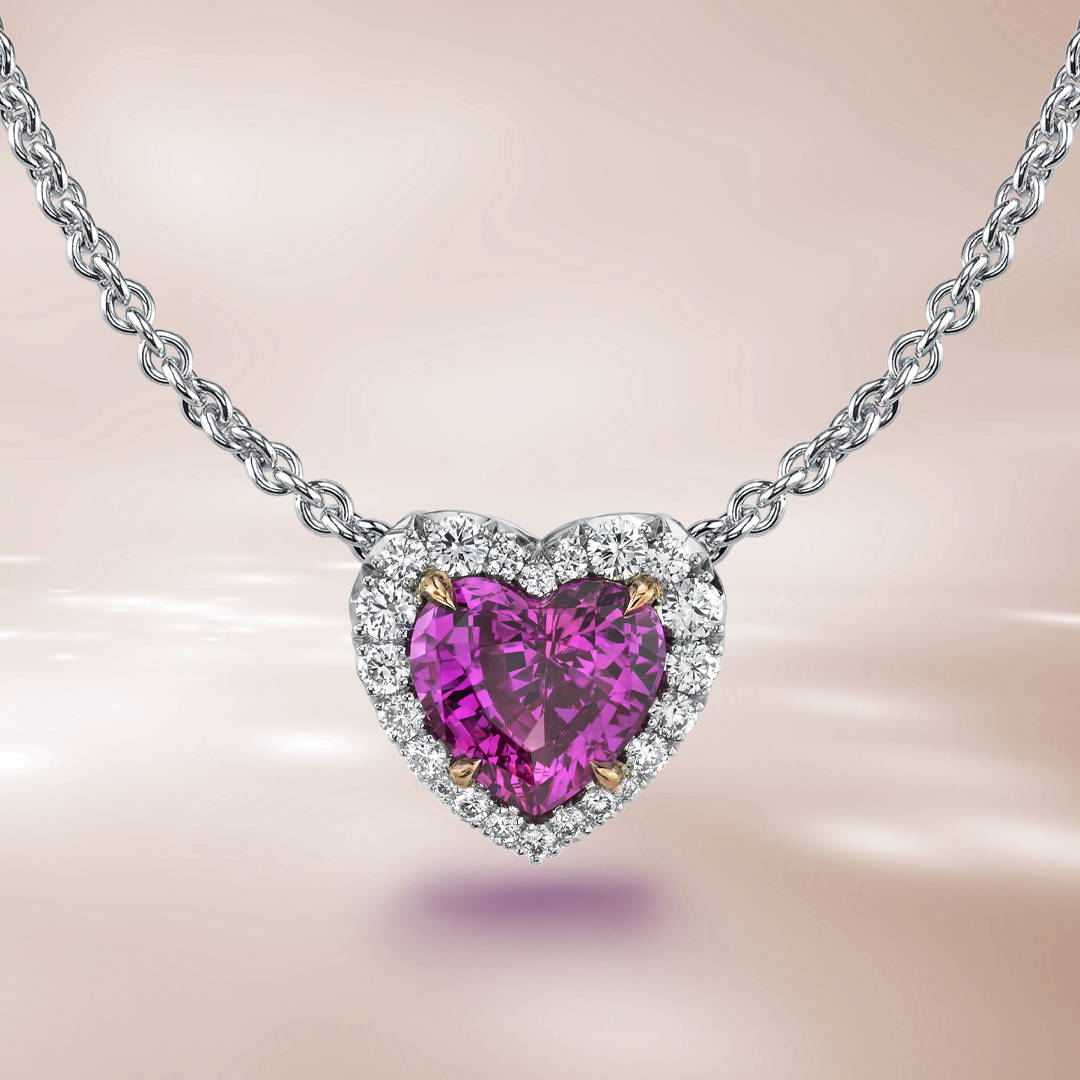Heart shaped pink sapphire with a diamond halo pendant necklace on a brown background