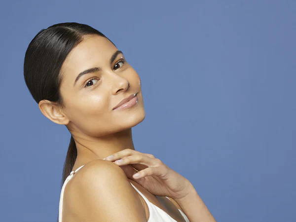 woman applying serum on her face 