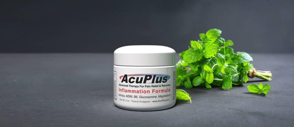 Fresh mint plants bundled up, next to an AcuPlus Pain Relief jar.