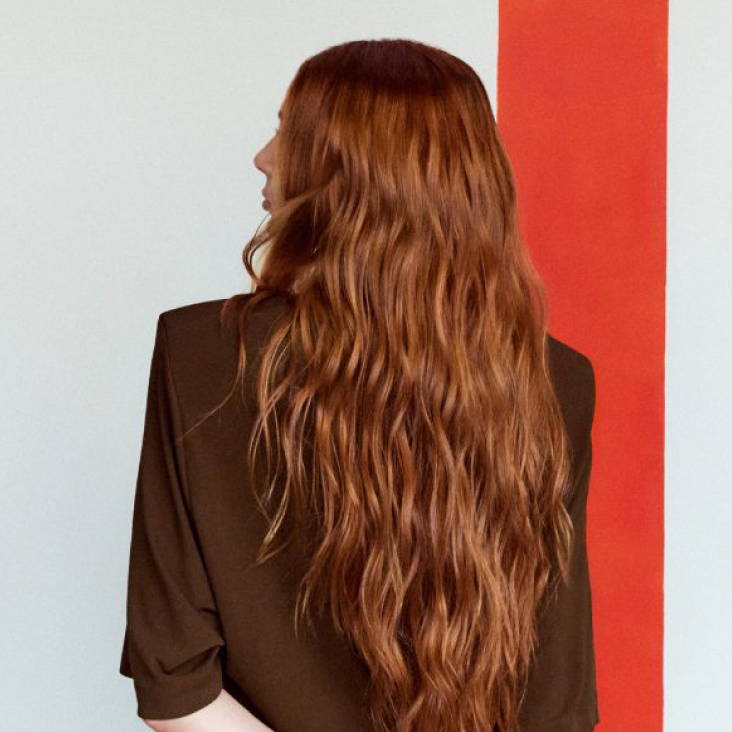 back of model with long, red hair