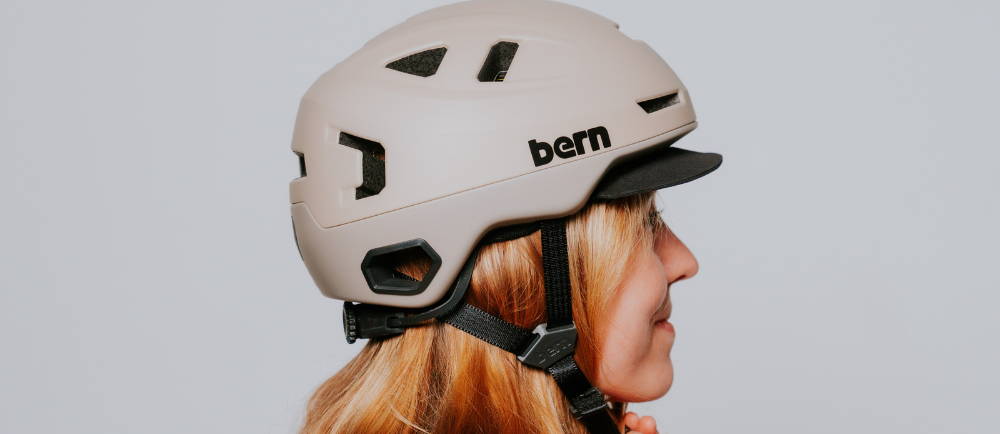 a woman wearing a white bern bike helmet
