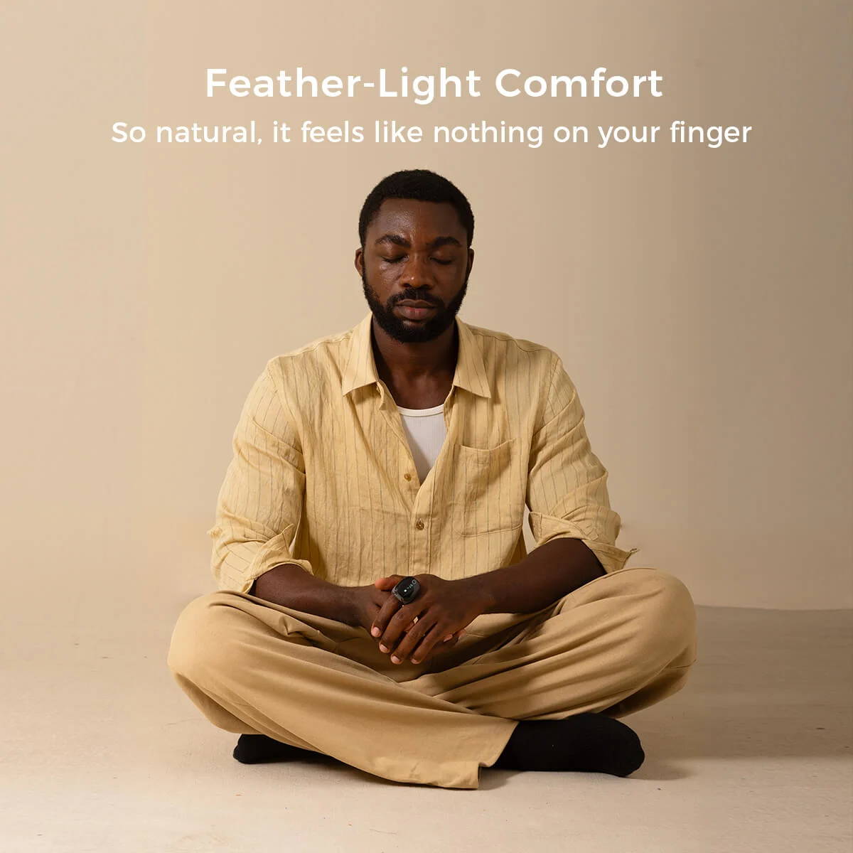 Man meditating while wearing Wellue O2Ring-S smart pulse oximeter, product box visible