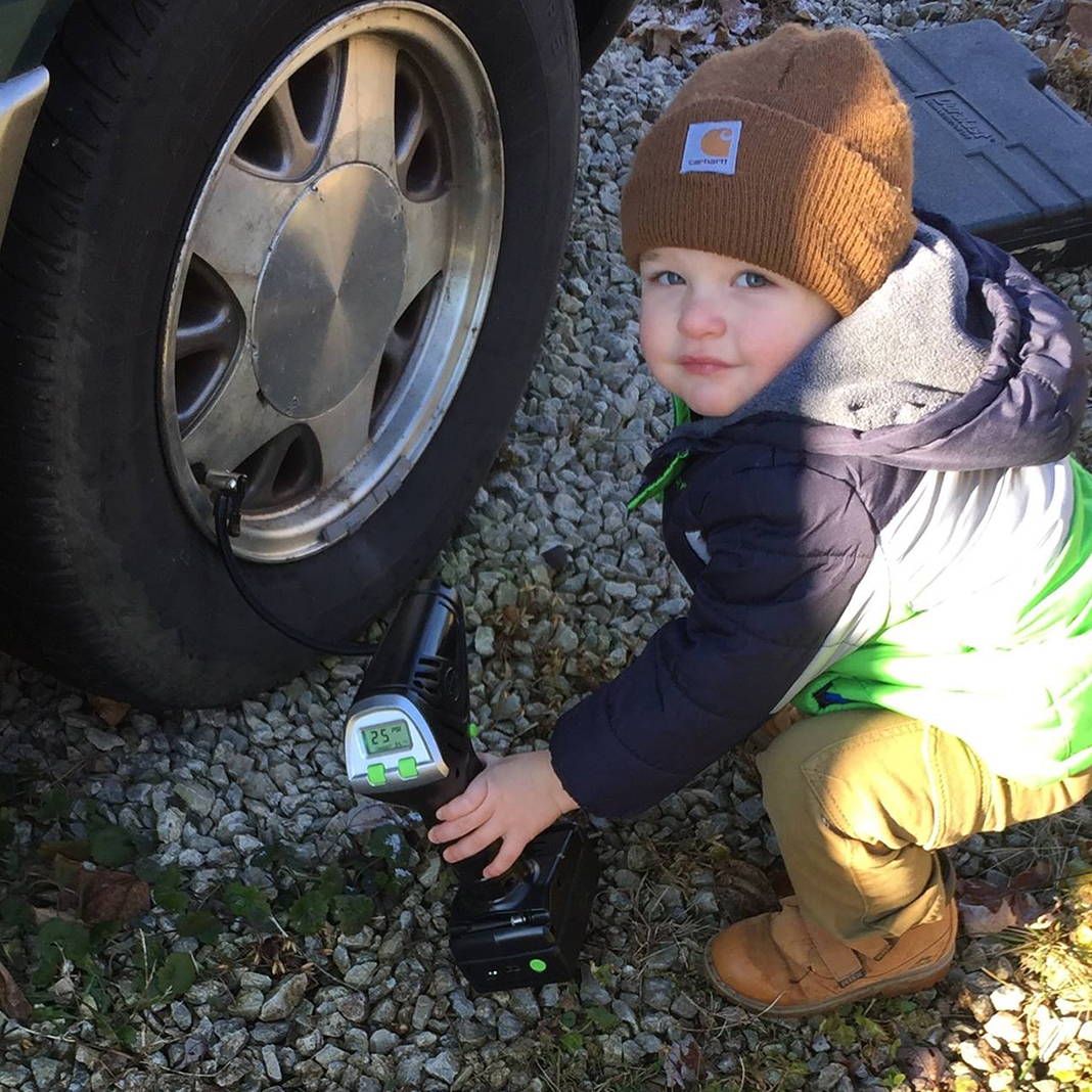 Little Kid using Slime Cordless Tire Inflator