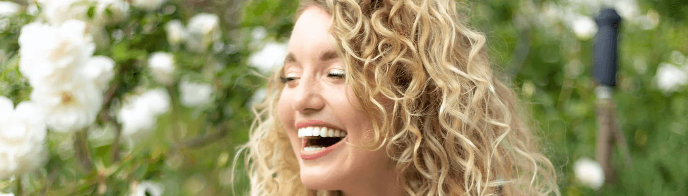 mini OI shampoo, OI milk, OI conditioner inside a packed suitcase