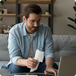Man sitting beside a laptop