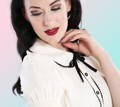 Model wearing Hell Bunny 1950s Calliste ivory top with hand to chin