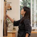 Calligrapher, Aoi Yamaguchi, in her atelier, deliberating on which of her large paint brushes to use.