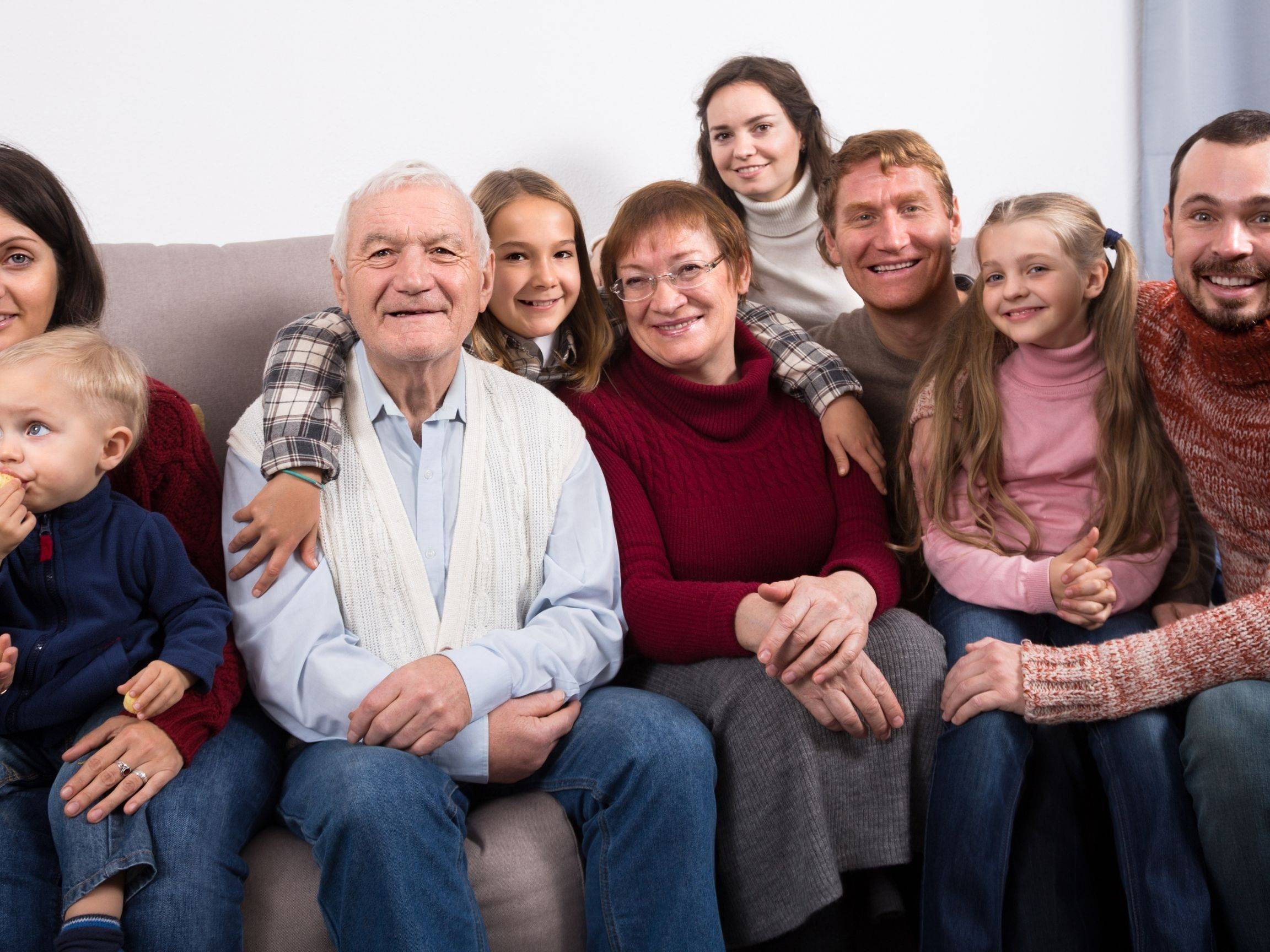 Extended family sitting together and surrounding Dad