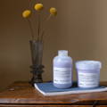 Davines Love Shampoo and Conditioner sitting on a table next to flowers
