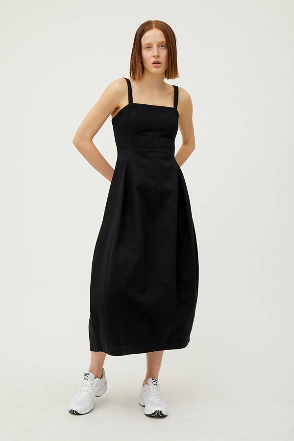 Front of woman wearing black organic cotton dress