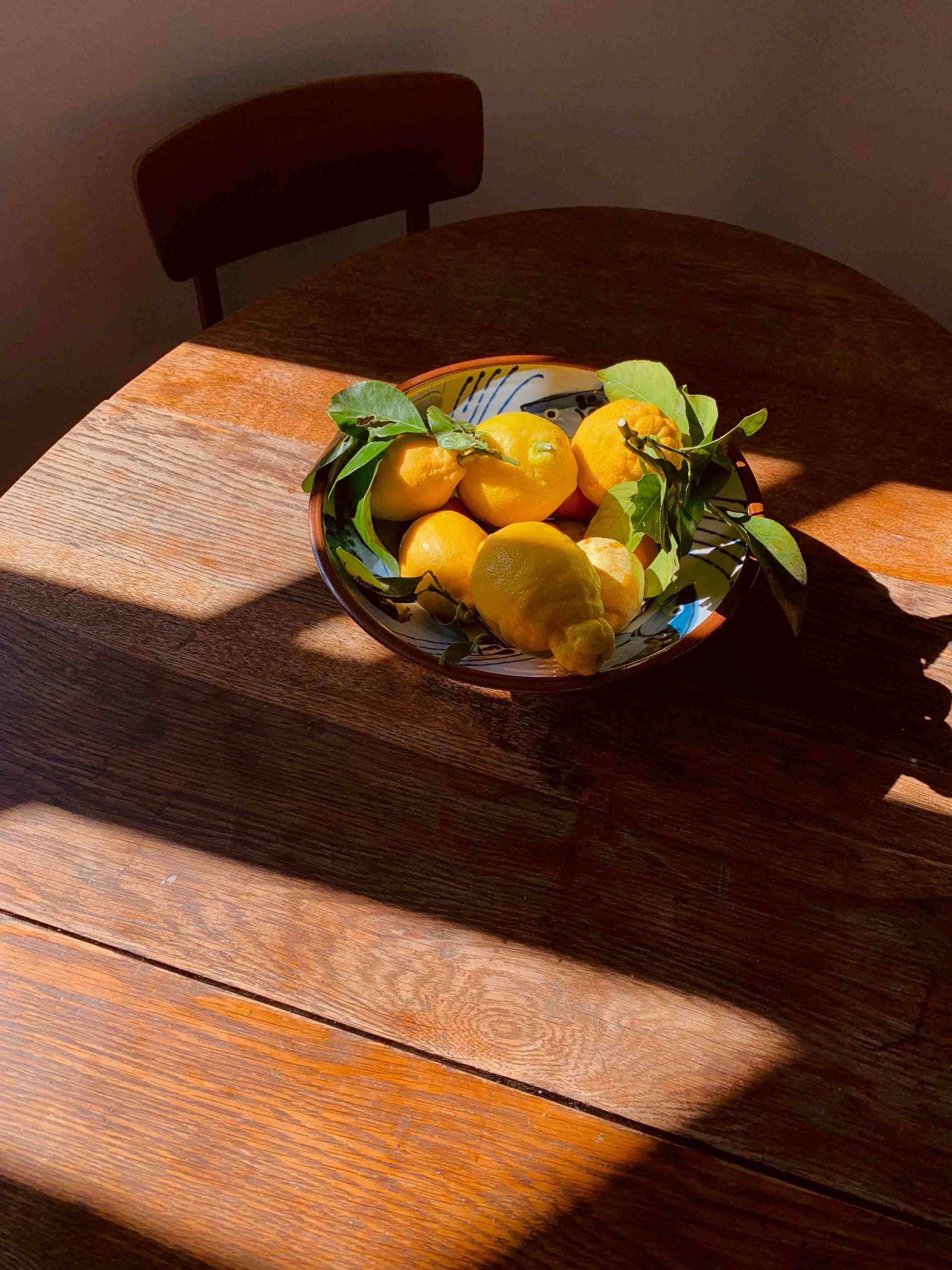 Lemons in the sunlight sitting  on a bench