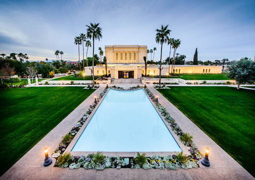 Mesa Temple reflection pool lined by flower beds and walkways.