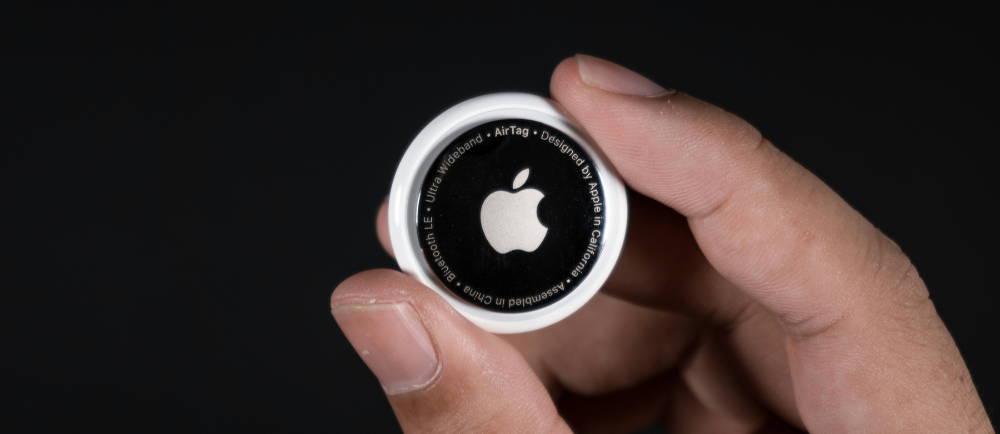 Hand holding Apple AirTag