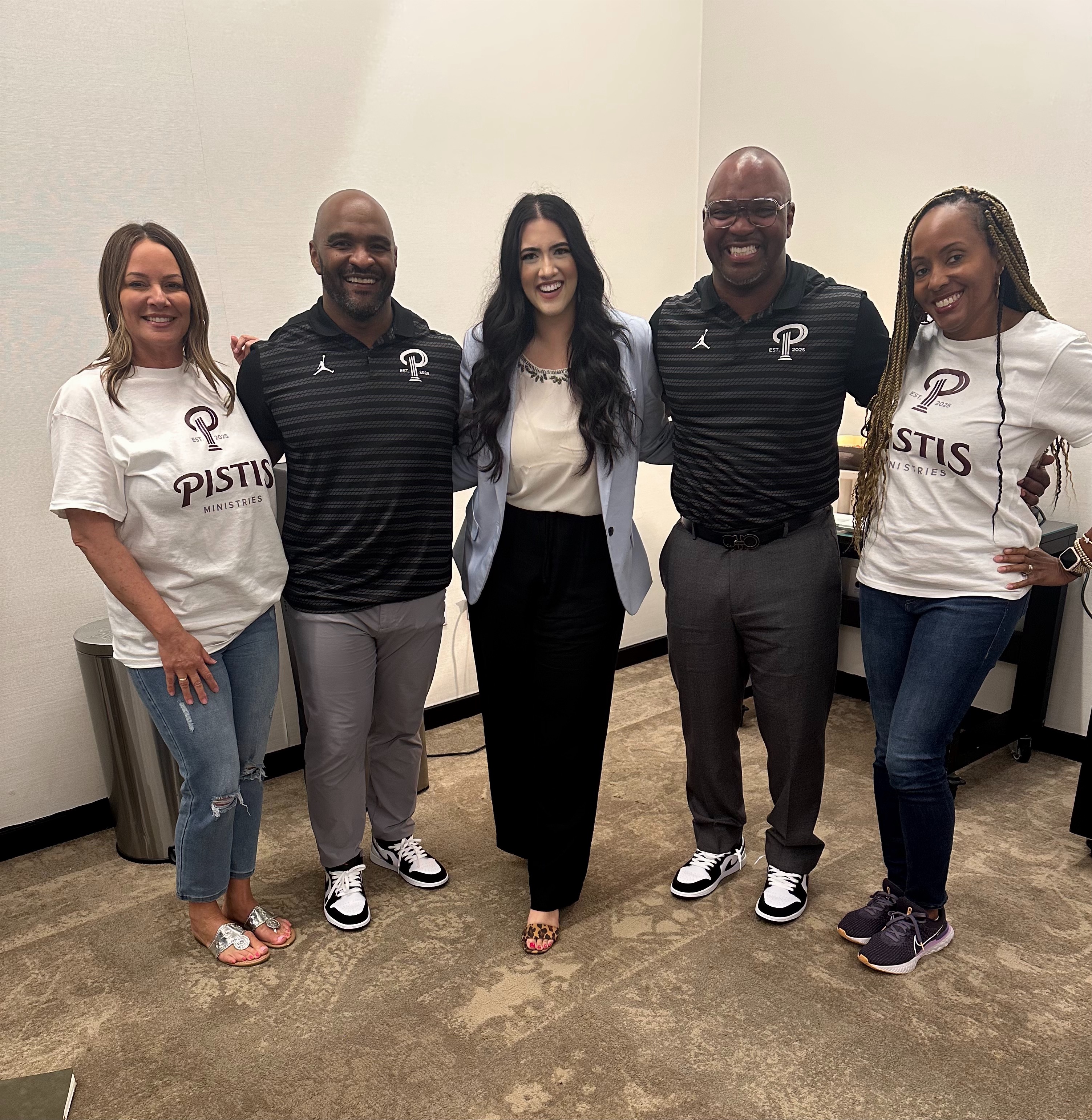 Group photo at Pistis Ministries event in P-logo shirts