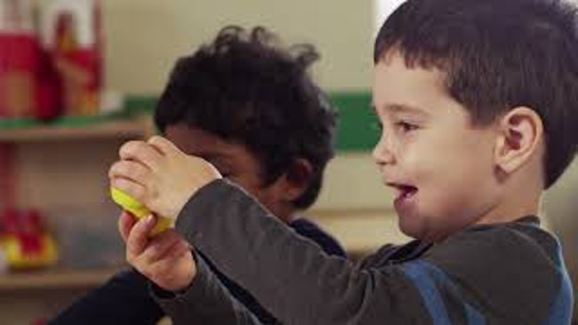 Child Playing with Toy in Preschool Class