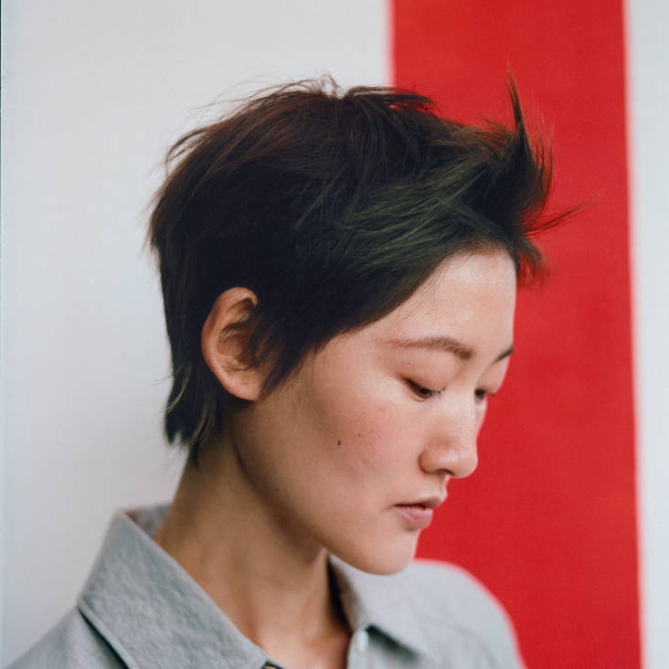 model looking down with dark, short hair