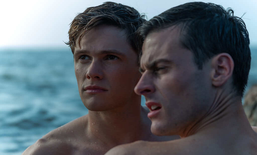 Close up of Sergey and Roman in water swimming close to one another looking at something out of frame.