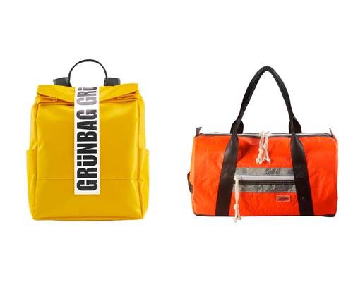 yellow recycled tarpaulin rucksack with black handles and large grunbag closure branding and orange sports holdall with black handles