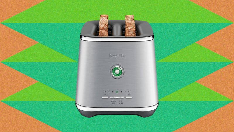 Front view of a silver 2-slot toaster with 2 pieces of bread sticking out
