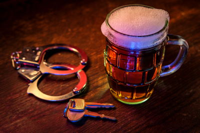 handcuffs keys and a beer