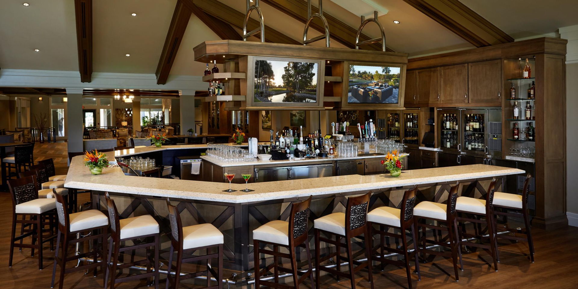 bar featuring a kitchen breakfast bar, a high ceiling, wood beam ceiling, natural light, dark hardwood floors, light countertops, and dark brown cabinetry