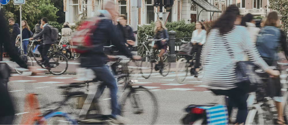 Lots of cyclist in motion at an intersection