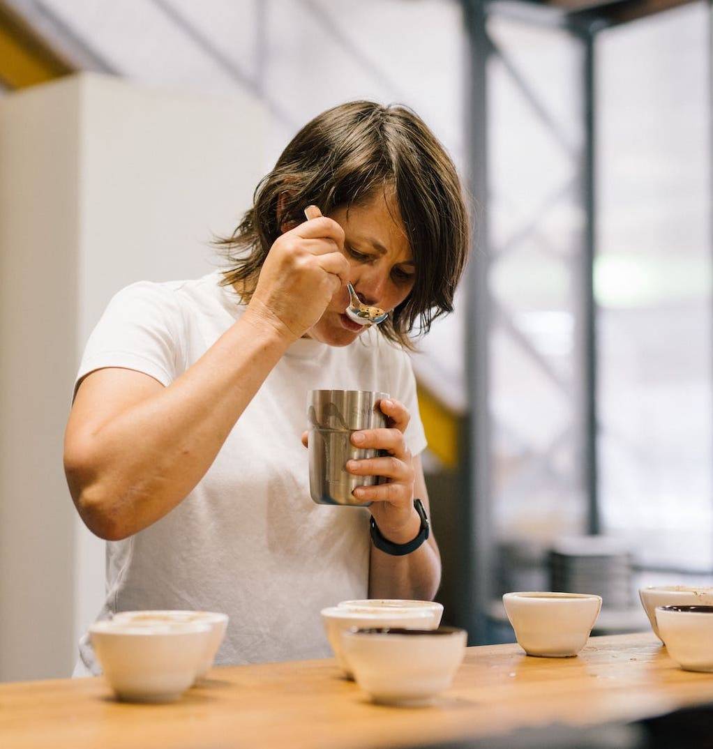 Person tasting coffee from a spoon