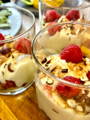 dessert glasses filled with cream of marscapone with raspberries