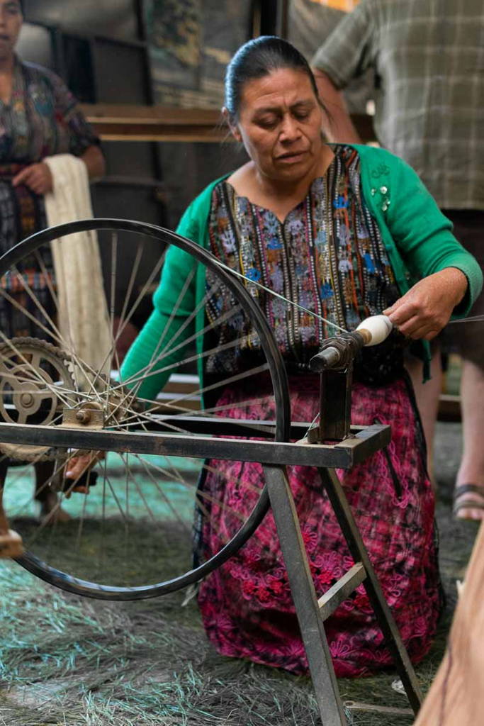 Mayan woman spinning thread