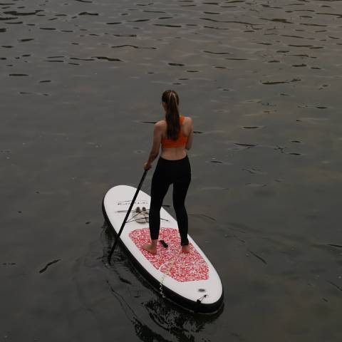Girl stand up paddleboarding in Canada water
